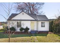 Charming home featuring a well-manicured lawn, cute front door, and cozy, inviting curb appeal at 2701 Newbold St, Raleigh, NC 27603