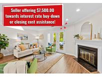 Inviting living room with neutral paint, fireplace, and access to patio at 3111 Coachmans Way, Durham, NC 27705