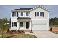 Charming two-story home with black shutters, white siding, a two-car garage, and a well-manicured lawn at 35 Calabria Ct, Franklinton, NC 27525