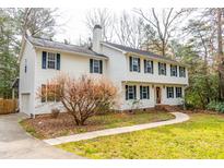 Charming two-story home featuring a well-manicured lawn and attached garage, perfect for families at 4324 Old Lewis Farm Rd, Raleigh, NC 27604