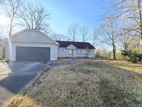 Charming single-story home with a well-manicured lawn and an attached garage, creating a welcoming curb appeal at 512 Monroe Holt Rd, Graham, NC 27253