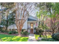 Charming home featuring a welcoming front porch, lush landscaping, and mature trees at 515 Swim & Croquet, Pittsboro, NC 27312