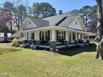 Charming home showcasing a spacious porch with inviting seating area, perfect for relaxing at 602 S Vermont St, Smithfield, NC 27577