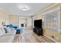 Comfortable living room with hardwood floors, neutral paint, and comfortable furniture at 7155 Old Fairground Rd, Benson, NC 27504