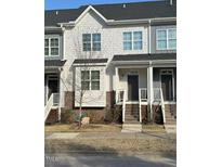Charming townhome with a stylish exterior, including brick accents, siding and inviting front steps at 829 S Franklin St, Wake Forest, NC 27587