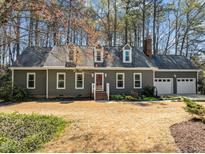 Charming home with a landscaped front yard, white trim, and a gray exterior at 8429 Bells Lake Rd, Apex, NC 27539
