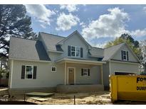 Charming gray home boasts a covered front porch and stylish black shutters at 902 Norwood Ln, Apex, NC 27502