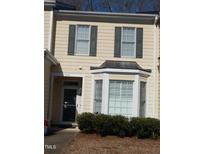 Charming townhome featuring a bay window, green shutters, and a well-maintained front yard at 903 Teague Pl, Durham, NC 27707