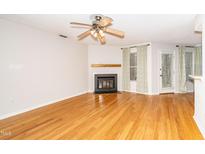 Inviting living room with fireplace, ceiling fan, and wood flooring at 109 Killam Ct # La, Cary, NC 27513