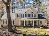 Charming two-story home with blue shutters and a welcoming front porch at 11619 John Allen Road Rd, Raleigh, NC 27614