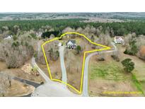 Beautiful home featuring an estimate of the property line situated on a generous lot, surrounded by mature trees at 1210 Poplar Forest Lane Ln, Pittsboro, NC 27312
