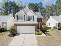 Charming two-story home with brick accents, attached garage, manicured landscaping, and a welcoming entryway at 156 River Pearl St, Raleigh, NC 27603