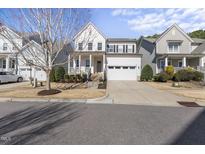Charming two-story home featuring a welcoming front porch and a spacious two-car garage at 1628 Highpoint St, Wake Forest, NC 27587