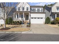 Charming two-story home with a well-manicured front yard and a two-car garage at 1628 Highpoint St, Wake Forest, NC 27587