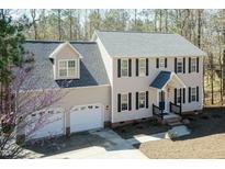 Charming two-story home featuring a two-car garage and a well-manicured front yard with a tree at 244 Victor Ct, Garner, NC 27529