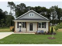 Charming single-story home with a welcoming front porch and well-manicured lawn at 274 Longbow Dr, Middlesex, NC 27557