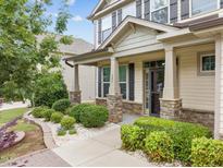 Inviting front porch with stone accents, mature landscaping, and craftsman-style details at 385 Ashberry Ln, Franklinton, NC 27525