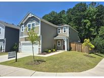 Charming two-story home with a well-maintained lawn, attached garage, and inviting front entrance at 4000 Passenger Pl, Durham, NC 27703