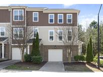 Charming townhome features a brick facade, attached garage, and a well-manicured lawn at 4121 Sykes St, Cary, NC 27519