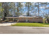 Charming brick home featuring a covered carport and front yard at 417 Baker St, Nashville, NC 27856