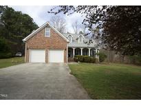 Charming brick and siding home with a two-car garage and covered front porch at 4336 N Greg Allen Way, Oxford, NC 27565