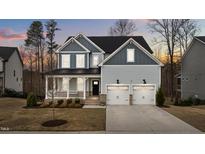 Charming two-story home featuring a welcoming front porch and a two-car garage at 505 Marion Hills Way, Knightdale, NC 27545
