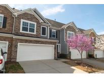 Townhome exterior with a two-car garage and beautiful blooming tree at 603 Mountain Pine Dr, Cary, NC 27519