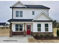 Charming two-story home featuring a striking red front door and a well-manicured lawn at 73 Legolas Ct, Middlesex, NC 27557