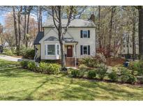 Charming two-story home featuring a landscaped front yard with brick steps to front door at 7804 Hilburn Dr, Raleigh, NC 27613
