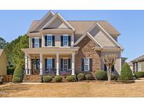 Beautiful two-story home with stone accents, large porch and professional landscaping at 804 Cambridge Hall Loop, Apex, NC 27539