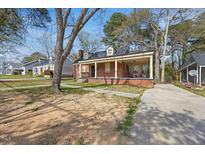Charming single-story brick home with a covered porch and a well-maintained front yard at 818 Eastern Ave, Rocky Mount, NC 27801