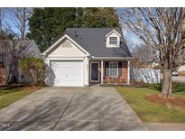 Charming home featuring a one-car garage, brick accents, and a well-maintained front yard at 9137 Colony Village Ln, Raleigh, NC 27617