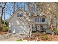 Charming two-story home with a well-manicured lawn and attached garage, perfect for suburban living at 12013 N Exeter Way, Raleigh, NC 27613