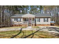 Charming single-story home features a ramp entrance, covered porch, and a well-maintained front yard at 170 Buckaroo Dr, Louisburg, NC 27549