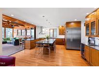 Open kitchen featuring a large island, stainless steel appliances, and hardwood floors at 1714 Park Dr, Raleigh, NC 27605
