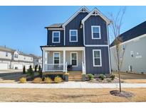 Charming two-story home with a welcoming front porch and beautifully landscaped front yard at 236 Annabelle Blue Dr, Wake Forest, NC 27587
