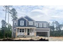 Two-story home with gray siding and a covered porch, awaiting its final touches at 266 Golfview Ave, Benson, NC 27504