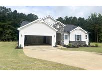New construction exterior with a two-car garage, stone accents, and manicured lawn at 283 Golfview Avenue, Benson, NC 27504