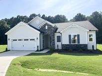 Charming single-story home with stone accents, attached garage, and well-manicured lawn at 283 Golfview Avenue, Benson, NC 27504
