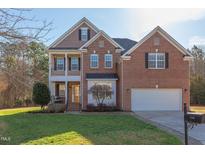 Beautiful two-story brick home with well-manicured lawn and attached two-car garage at 3708 Tansley St, Wake Forest, NC 27587