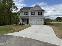 Charming two-story home featuring a spacious driveway and well-manicured front yard at 4005 Kingcraig Ln, Zebulon, NC 27597