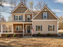 Charming two-story home featuring a welcoming front porch and a beautifully landscaped yard at 424 Hocutt Farm Dr, Clayton, NC 27527