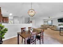 Cozy dining area featuring a dark wood table with seating for four and an open view to the living room at 6817 Osprey Landing Dr, Wendell, NC 27591