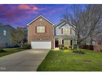 Charming two-story home with brick and siding, plus a well-manicured lawn and attached garage at 6817 Osprey Landing Dr, Wendell, NC 27591