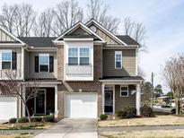 Charming townhouse featuring a brick facade and a one-car garage at 700 Treviso Ln, Apex, NC 27502