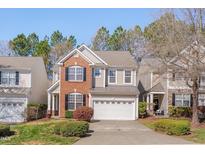 Charming two-story home with brick and siding, well-manicured lawn, and two car garage at 7920 Leonardo Dr, Durham, NC 27713