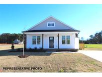 Charming single-story home featuring a welcoming front porch and a well-manicured lawn at 87 Legolas Ct, Middlesex, NC 27557