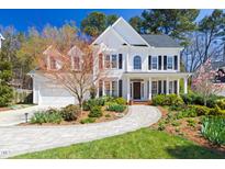 Stunning two-story traditional home with manicured landscaping and a charming brick walkway at 9 Morgans Ridge Ln, Durham, NC 27707