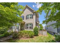 Charming two-story home with a well-manicured lawn and inviting curb appeal, showcasing a cozy residential atmosphere at 105 Della St, Chapel Hill, NC 27516