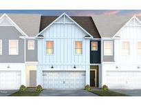 Charming townhome featuring an attached garage and a beautifully designed modern exterior at 1115 Everton Ave, Durham, NC 27703
